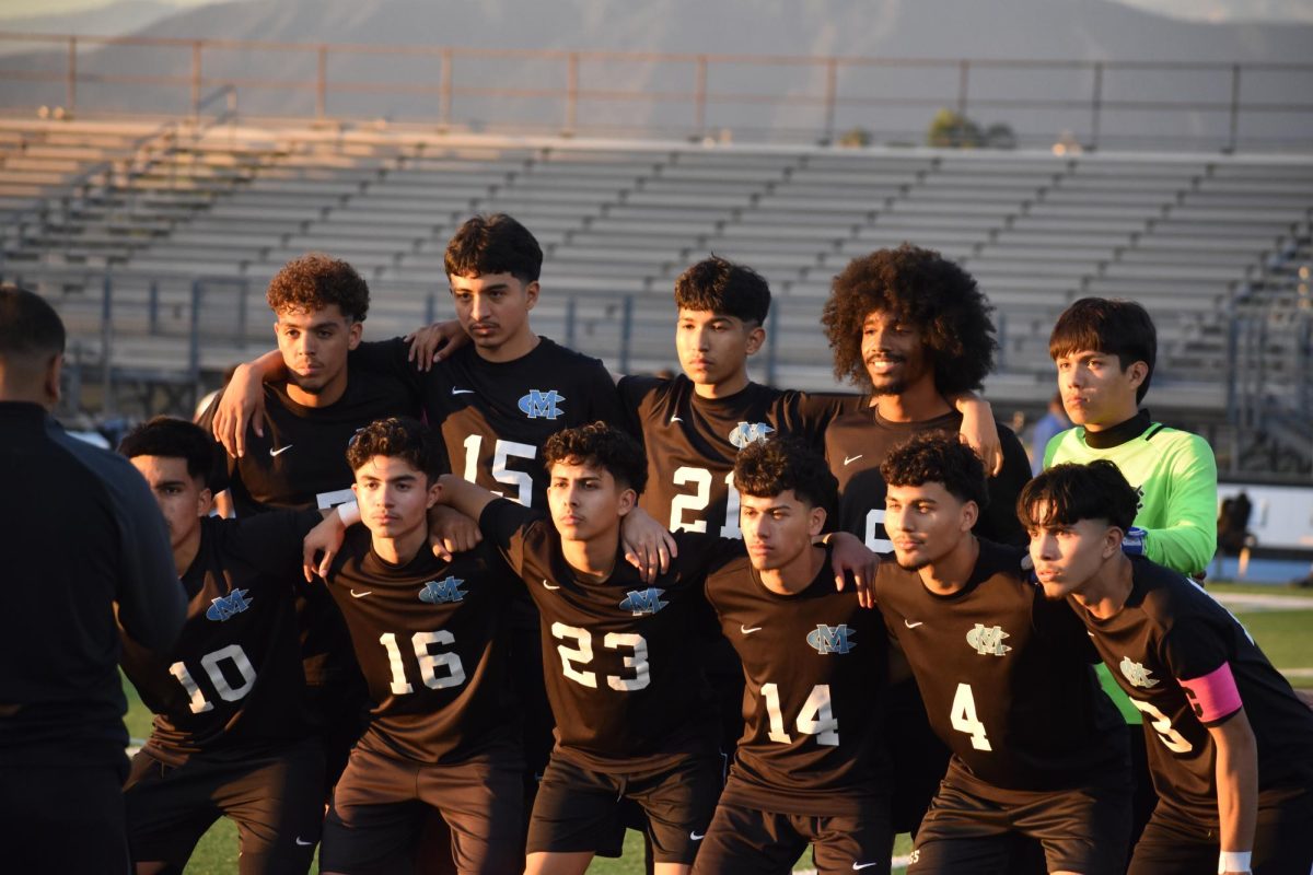 The Boys Varsity Soccer seniors taking a picture before their game.